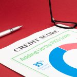 Credit score report with pen and notepad.