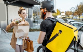 A courier working for a food delivery app, that is ruining our relationship with cooking.