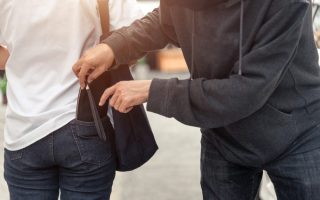 Pickpocket stealing a woman's wallet