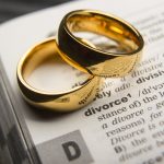 A pair of rings sitting on the dictionary definition of 