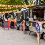 A group of food trucks in one of the cities that offer incedible food scenes without high costs