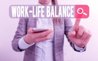 A business woman with the words "work-life balance" on the screen