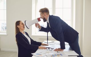 An employee using a megaphone to scream at his boss after deciding to quit