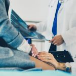 Doctor and patient discussing scan results in diagnostic center