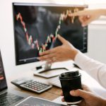 Business people talking and analysis with profit from the screen