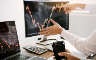 Business people talking and analysis with profit from the screen