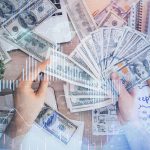 Multi exposure of financial graph drawing hologram and USA dollars bills and man hands