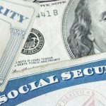 Social security cards on a $100 bill