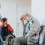 A worried senior man in a nursing home