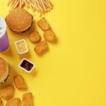 Fast food choices laying on a yellow background