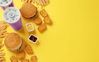 Fast food choices laying on a yellow background