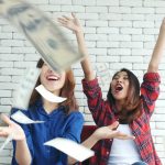 A couple of friends who are throwing money around and having conversations about cash