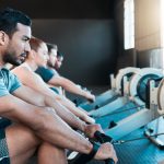Meeting someone new at the gym among a bunch of strangers on rowing machines
