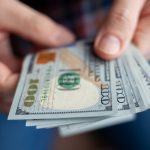 Close up of male hands counting money