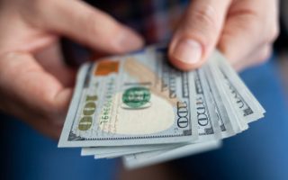 Close up of male hands counting money
