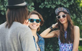 Two young woman communicate with a man