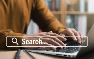 A man using a search engine on his laptop