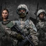 Squad of three soldiers against grey background