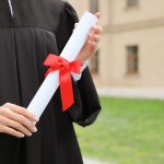 Student with diploma after graduation ceremony