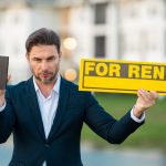 Real estate agent holding a cell phone and 