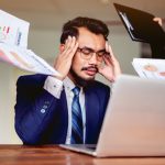 An employee tired from all of the work they receive and the legal loopholes their employers jump through to pay them nothing