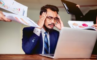 An employee tired from all of the work they receive and the legal loopholes their employers jump through to pay them nothing