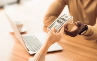 A woman handing a man a loan