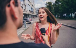 A woman speaking in public on a microphone