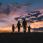 A familiy moving ahead in the distance and thinking of a future