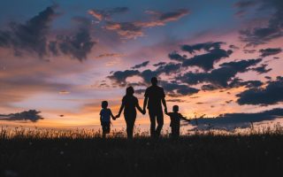 A familiy moving ahead in the distance and thinking of a future