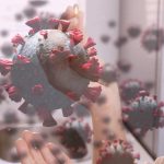 An image of small diseases in the air with a woman in the background