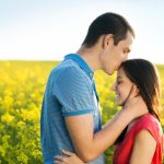 A happy husband kissing his wife on the forehead