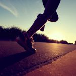 Young woman outside running in the sun