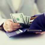 A full wallet of a woman who is out-earning her parents