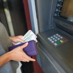 Woman pulling money out of an ATM