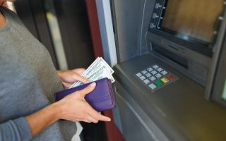 Woman pulling money out of an ATM