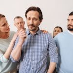 Familiy members making their adult son feel guilt about his success
