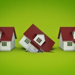 Image of three model houses, with the one in the middle falling into a hole