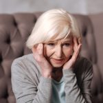 Close up aged woman with headache