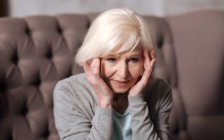 Close up aged woman with headache