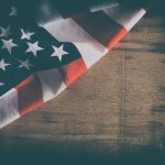 American flag close up on wood desk