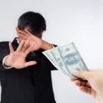 A man going through an act of self-sabotage and rejecting money he shoud have
