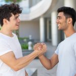Two men clasping hands and building a friendship
