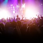 A concert filled with many fans, all paying a high price to see singers