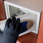 Someone storing their valuables in a safe