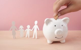 A family filling a piggy bank for their financial plans