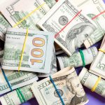 A pile of rolled up cash, which can go away if your cash flow is affected