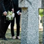 A family at a graveyard, dealing with a death in the family
