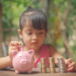 A young child picking up financial mindset habits that she learned by watching her parents