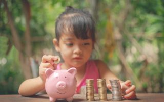 A young child picking up financial mindset habits that she learned by watching her parents